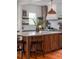 Bright kitchen featuring open shelving, butcher block accents and an expansive center island at 1153 King St, Charleston, SC 29403