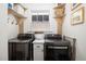 This is a laundry room with modern washer and dryer units and built-in shelves at 1153 King St, Charleston, SC 29403
