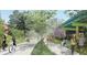 Scenic walking and bike path surrounded by lush trees, offering recreational opportunities for residents at 1153 King St, Charleston, SC 29403