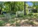 Fenced backyard featuring a greenhouse, tool shed and vegetable garden at 1192 Church Of God Rd, Bonneau, SC 29431