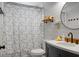 Bathroom featuring dark vanity with white sink, dark faucet, and decorative shower curtain at 1192 Church Of God Rd, Bonneau, SC 29431