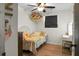 Bedroom featuring wood floor, overhead fan, window, and rainbow decoration on the wall at 1192 Church Of God Rd, Bonneau, SC 29431