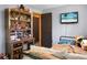 Comfortable bedroom featuring hardwood floors, decorative shelving and desk at 1192 Church Of God Rd, Bonneau, SC 29431