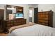 Primary bedroom suite with hardwood flooring and a bathroom visible through doorway at 1192 Church Of God Rd, Bonneau, SC 29431