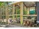 Wooden chicken coop with many chickens enjoying the shade at 1192 Church Of God Rd, Bonneau, SC 29431