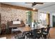 Dining room with hardwood floors, brick wall accents, and a rustic farmhouse table at 1192 Church Of God Rd, Bonneau, SC 29431