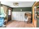 A modern entryway with a rattan chair, wood accents, and a decorative wall at 1192 Church Of God Rd, Bonneau, SC 29431