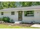 The home's front door is accessible from a garden path with meticulous landscaping at 1192 Church Of God Rd, Bonneau, SC 29431