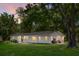 Charming single-story home featuring a well-maintained lawn and large, mature trees at 1192 Church Of God Rd, Bonneau, SC 29431