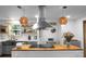 Bright kitchen featuring a stainless steel range hood and modern pendant lighting at 1192 Church Of God Rd, Bonneau, SC 29431