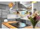 A close-up of a grey kitchen showcasing a stainless steel sink and modern faucet at 1192 Church Of God Rd, Bonneau, SC 29431