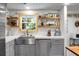 Beautiful kitchen with white countertops, stainless steel appliances and wood shelves at 1192 Church Of God Rd, Bonneau, SC 29431