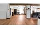 Open-concept living room featuring wood floors, modern accents, and exposed wood beam supports at 1192 Church Of God Rd, Bonneau, SC 29431