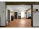 Open concept living room with modern decor, hardwood flooring, and ample natural light at 1192 Church Of God Rd, Bonneau, SC 29431