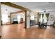 Open-concept living space with exposed wood beams and hardwood floors at 1192 Church Of God Rd, Bonneau, SC 29431