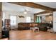 Relaxing living room featuring hardwood floors, wooden support beams, and a comfortable, oversized sectional sofa at 1192 Church Of God Rd, Bonneau, SC 29431
