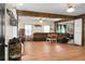 Open living room featuring hardwood floors, wooden support beams, and a comfortable, oversized sectional sofa at 1192 Church Of God Rd, Bonneau, SC 29431