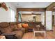 Relaxing living room featuring hardwood floors, wooden support beams, and a comfortable, oversized sectional sofa at 1192 Church Of God Rd, Bonneau, SC 29431