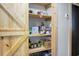 Pantry room featuring shelving with food and small appliances, and a bright wood door at 1192 Church Of God Rd, Bonneau, SC 29431