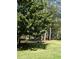 Spacious lawn featuring an inviting bench and lush trees that are perfect for picnics and outdoor gatherings at 1202 Ventura Pl, Mount Pleasant, SC 29464