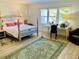 Bright bedroom features a large window, unique decor, and a vintage-style bed at 1202 Ventura Pl, Mount Pleasant, SC 29464