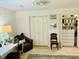 Well-lit bedroom with a cozy reading nook, closet space, and a large patterned rug at 1202 Ventura Pl, Mount Pleasant, SC 29464
