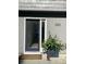 Front door of a gray home with black trim, modern house numbers, and greenery at 1202 Ventura Pl, Mount Pleasant, SC 29464