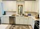 Bright kitchen with white cabinetry, quartz countertops, stainless steel appliances, and tiled backsplash at 1202 Ventura Pl, Mount Pleasant, SC 29464