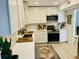 Clean white kitchen with modern appliances, a subway tile backsplash and an island sink at 1202 Ventura Pl, Mount Pleasant, SC 29464