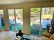 Bright living room view through sliding glass doors to the outdoor patio with lounge chairs at 1202 Ventura Pl, Mount Pleasant, SC 29464