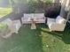 Outdoor patio with plush white couches and a quaint stone coffee table surrounded by greenery at 1202 Ventura Pl, Mount Pleasant, SC 29464