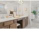 Bathroom boasts dual sinks, vanity, and shower with modern fixtures and elegant decor at 1206 Homecoming Blvd, Ravenel, SC 29470
