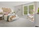 Bright bedroom features a woven headboard, comfortable seating, and an abundance of natural light at 1206 Homecoming Blvd, Ravenel, SC 29470