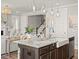 Spacious kitchen with a large island featuring a farm sink, pendant lighting and stainless steel appliances at 1206 Homecoming Blvd, Ravenel, SC 29470