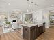 Kitchen island with granite countertop and stainless steel appliances, seamlessly flowing into the living room at 1206 Homecoming Blvd, Ravenel, SC 29470