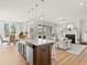 Open-concept kitchen and dining area featuring a large island with pendant lighting and stainless steel appliances at 1206 Homecoming Blvd, Ravenel, SC 29470