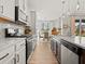 Well-equipped kitchen featuring stainless steel appliances and granite countertops that opens to a dining area at 1206 Homecoming Blvd, Ravenel, SC 29470
