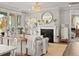 Elegant living room featuring a fireplace, stylish decor, and a view into the Primary bedroom at 1206 Homecoming Blvd, Ravenel, SC 29470
