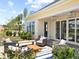 Back patio with comfortable seating, outdoor rug, and a bright yellow home exterior at 1206 Homecoming Blvd, Ravenel, SC 29470