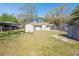 Expansive backyard showcasing a lush lawn, mature trees, and multiple storage sheds at 1230 Hawthorne Cir, Hanahan, SC 29410