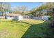 A view of a large backyard with green grass and a variety of storage sheds at 1230 Hawthorne Cir, Hanahan, SC 29410