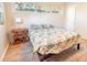 Bedroom with light grey carpet and a queen bed, a table lamp, and three bright windows at 1230 Hawthorne Cir, Hanahan, SC 29410