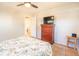 Bedroom featuring a cherry dresser with TV and ceiling fan in a neutrally painted room at 1230 Hawthorne Cir, Hanahan, SC 29410