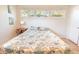 Bright bedroom featuring a large window and a queen bed with a patterned comforter at 1230 Hawthorne Cir, Hanahan, SC 29410