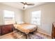 Cozy bedroom with fan, light wood floor, area rug, and windows at 1230 Hawthorne Cir, Hanahan, SC 29410
