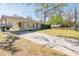 Traditional home featuring a carport and long driveway, surrounded by a lush green lawn at 1230 Hawthorne Cir, Hanahan, SC 29410