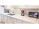 White kitchen with sink, stainless steel faucet, microwave, and coffee maker at 1230 Hawthorne Cir, Hanahan, SC 29410
