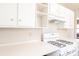 Clean kitchen with bright white cabinets, countertop, and gas range stove at 1230 Hawthorne Cir, Hanahan, SC 29410