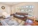 Bright living room featuring large windows, a plush sofa, a stylish rug, and hardwood floors at 1230 Hawthorne Cir, Hanahan, SC 29410