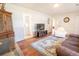Inviting living room features hardwood floors, large area rug, and comfortable seating arrangement at 1230 Hawthorne Cir, Hanahan, SC 29410